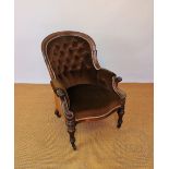A Victorian carved walnut salon chair, on turned legs,