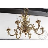 A 19th century style brass six branch chandelier, with foliate sconce arms,