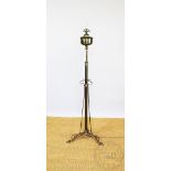 An Edwardian Arts and Crafts style adjustable brass standard oil lamp,
