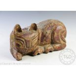 A 20th century carved wood model of a seated cat, with red and gilt painted decoration,