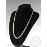 A 9ct yellow gold Figaro type fancy link chain, import mark for London 1990,