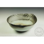 Jane Perryman (British b1947) a studio pottery ovoid bowl, the shaped rim with geometric detailing,
