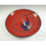John Eagle (Australian) a large stoneware bowl, decorated with leaves against a burnt red ground,