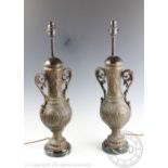 A pair of late Victorian spelter table lamps, converted for electricity, with floral detailing,