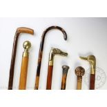 A collection of seven walking cane to include a silver mounted example,