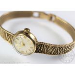 A lady's 9ct gold Omega wrist watch, with numeral and baton dial and case numbered 7115656,