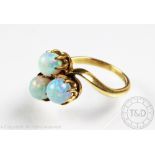 A three stone untested opal ring, each circular opal claw set in trefoil shape,