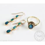 A pair of 'black opal' set drop earrings, each set with a drop of three graduated, untested opals,