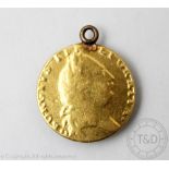 A George III gold spade Guinea coin dated indistinctly 1791, shield back, soldered pendant mount,
