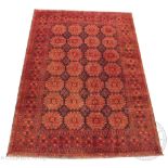 A Baluch hand woven wool carpet, worked with twenty eight gulls against a black and red ground,
