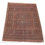 A Kilim Chobi wool rug, worked with overall geometric panels against a beige ground,