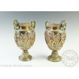 A pair of silver plated bacchanalian vases in the manner of Elkington,