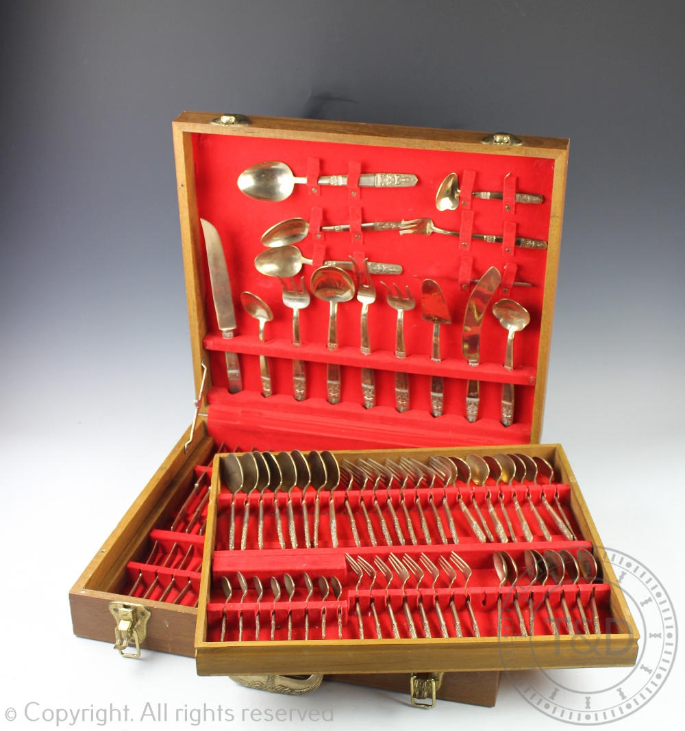 A cased canteen of gilt metal cutlery set, Thai, each piece cast with Buddha terminal,