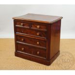 A Victorian mahogany commode chest, with faux drawer front,