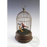A clockwork musical automaton, the domed brass enclosure with two birds upon branches within,