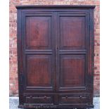 A 17th century oak livery cupboard, the panelled carcass,