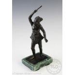 A late 19th century Burmese bronze model of a fisherman,