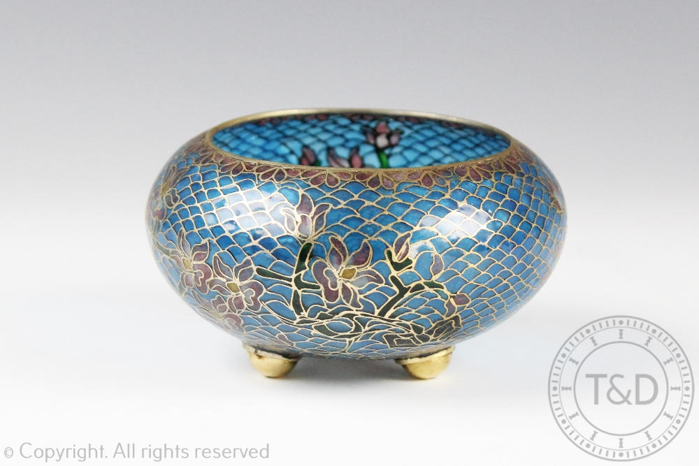 An early 20th century plique a jour tripod bowl, decorated with floral vines, on three bun feet, 10.