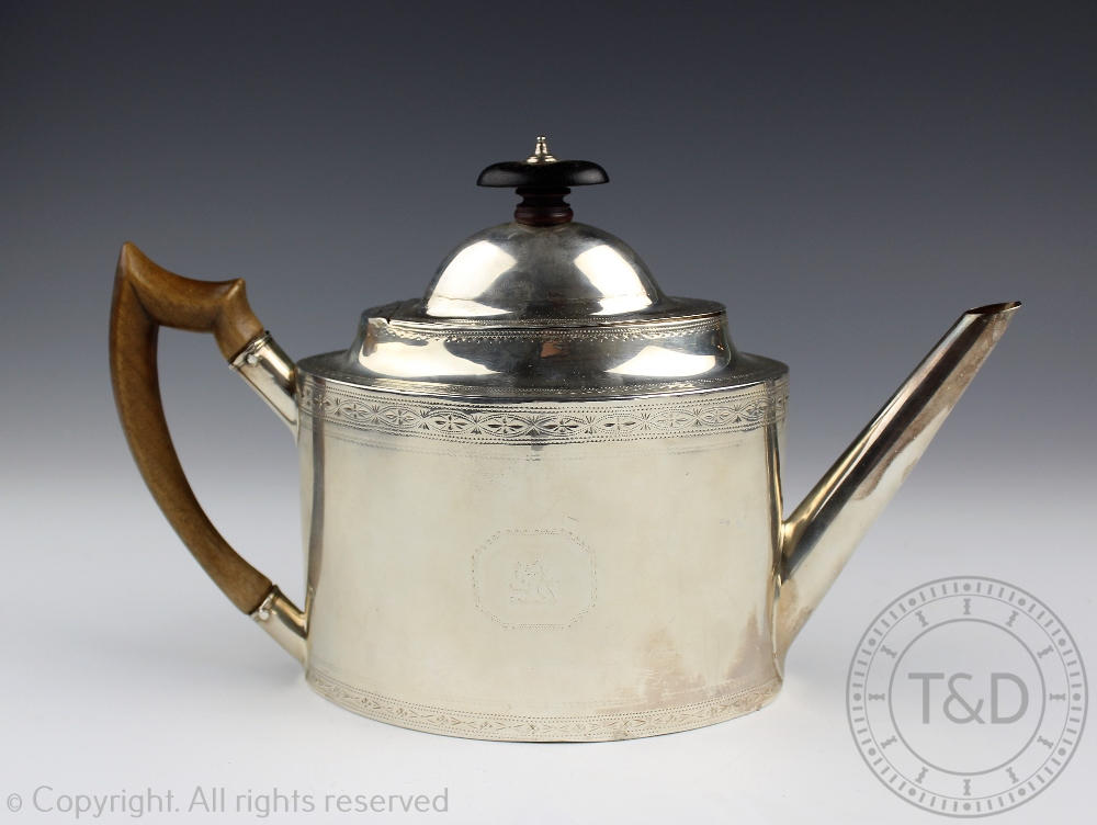 An Irish silver teapot Dublin circa 1800, of straight sided oval form and with chased borders,