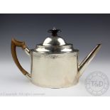 An Irish silver teapot Dublin circa 1800, of straight sided oval form and with chased borders,