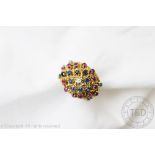 A multi gem set ring, circa 1970, the bombe shaped ring set with a central diamond,