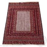 A Kilim wool rug, worked with overall geometric panels against a red ground,