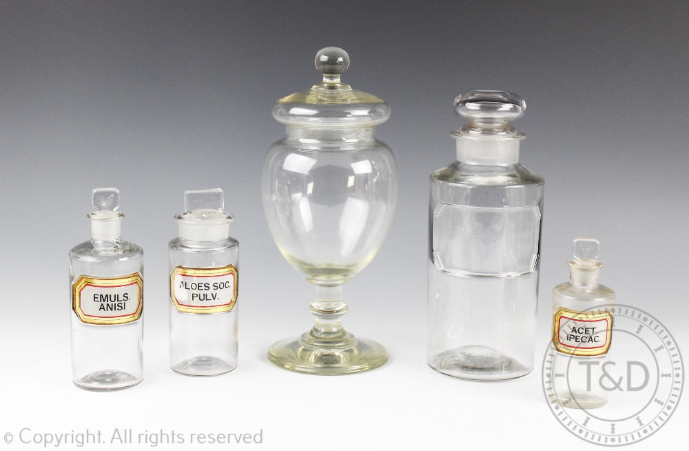 A selection of early 20th century apothecary bottles, to include three labelled examples,