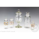 A selection of early 20th century apothecary bottles, to include three labelled examples,