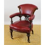 A Victorian carved oak library chair, with red leather upholstered back,