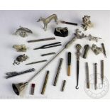 A collection of silver plated and white metal items to include a stag head handled candle snuffer,