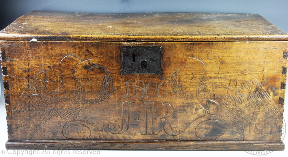 A 19th century oak chest, the hinged top above carved bird detail and '1800' 'J*R' 33.