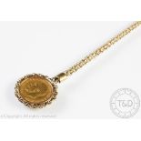 A George V gold half sovereign dated 1912, within yellow metal mount and chain surround,