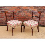 A pair of Regency mahogany dining chairs, with later upholstered seats, on turned and fluted legs,