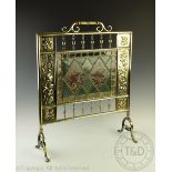 A 19th century Aesthetic brass and stained glass fire screen, the glass decorated with birds,