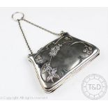 An Edwardian silver purse, of traditional form and with embossed flowering foliage design,