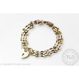 A 9ct gold gate bracelet, the four bar gate with attached heart shaped padlock clasp, weight 7.