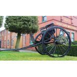 A two seater horse drawn buggy, black painted with applied gilt line detailing, with rubber wheels,