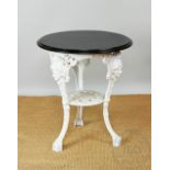 A white painted cast iron pub table, with ebonised top, on stand with female masks,