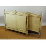 A French painted headboard and footboard, with carved urn detail,