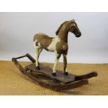 A Victorian rocking horse, the Skewbald pony with horse hide and hair mane, leather saddle,