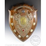 A large Edwardian silver plate and copper mounted trophy shield for 'First Aid Workshops' 'The