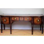 A George III inlaid mahogany bow front side board of country house proportions,