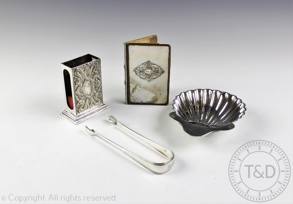 A selection of silver comprising; a Victorian silver shell shaped salt, Josiah Williams & Co,