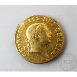 A George III 'military type' Guinea coin, dated 1813, sixth laureate head right,