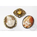 Three brooches, to include; a carved shell cameo brooch depicting classical figures,