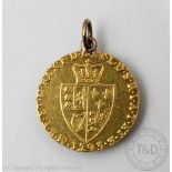 A George III gold spade Guinea coin dated 1793, shield back, soldered pendant mount, gross weight 8.