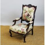 A Victorian carved walnut salon chair, with floral upholstery on cabriole legs 100cm H,