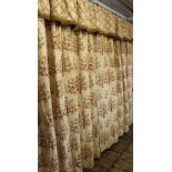 A pair of curtains, each cream ground with tree of life design in autumnal colours, each lined,