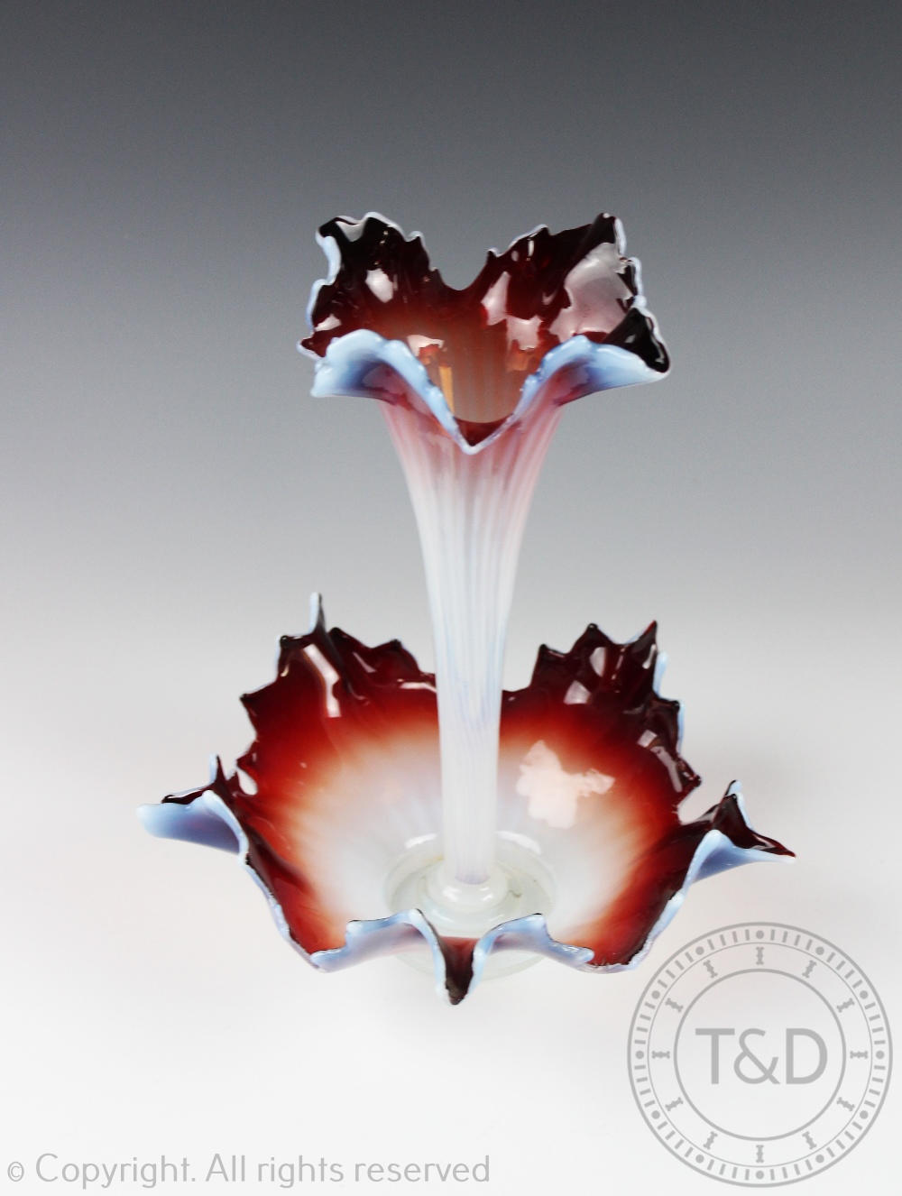 A Victorian vaseline glass epergne, the central flute supported by a bowled base, leaf cut rims, 28.