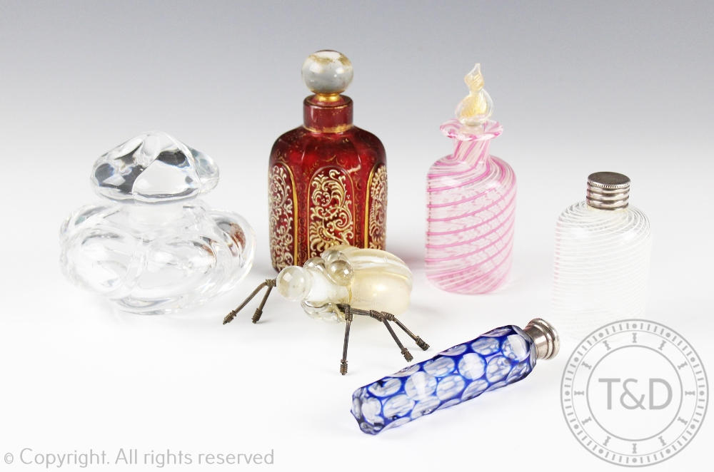 A selection of glass scent bottles and stoppers comprising; a Baccarat example, 9cm high,